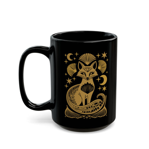 A black ceramic mug featuring a stylized golden fox design surrounded by Art Deco ginkgo fans, crescent moons, and stars. The mug has a glossy finish and ergonomic handle.